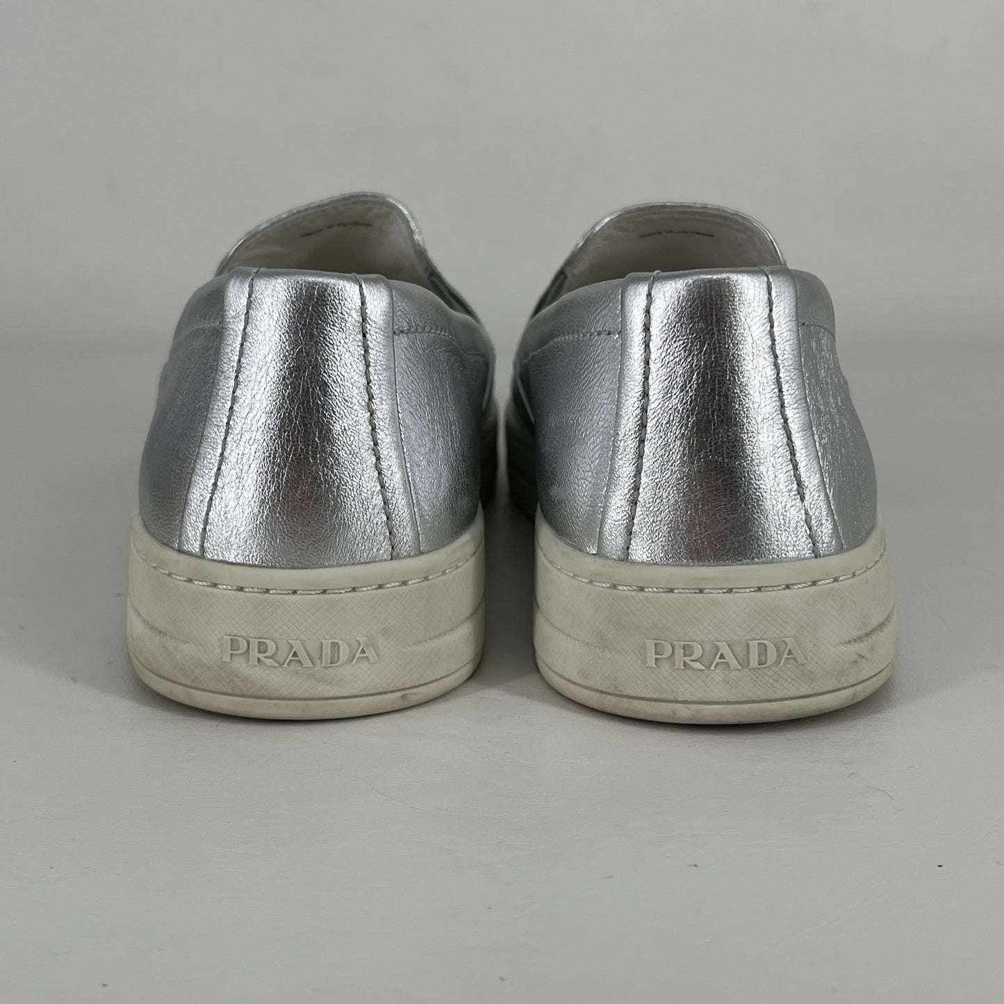 Authentic Prada Silver Slip-ons